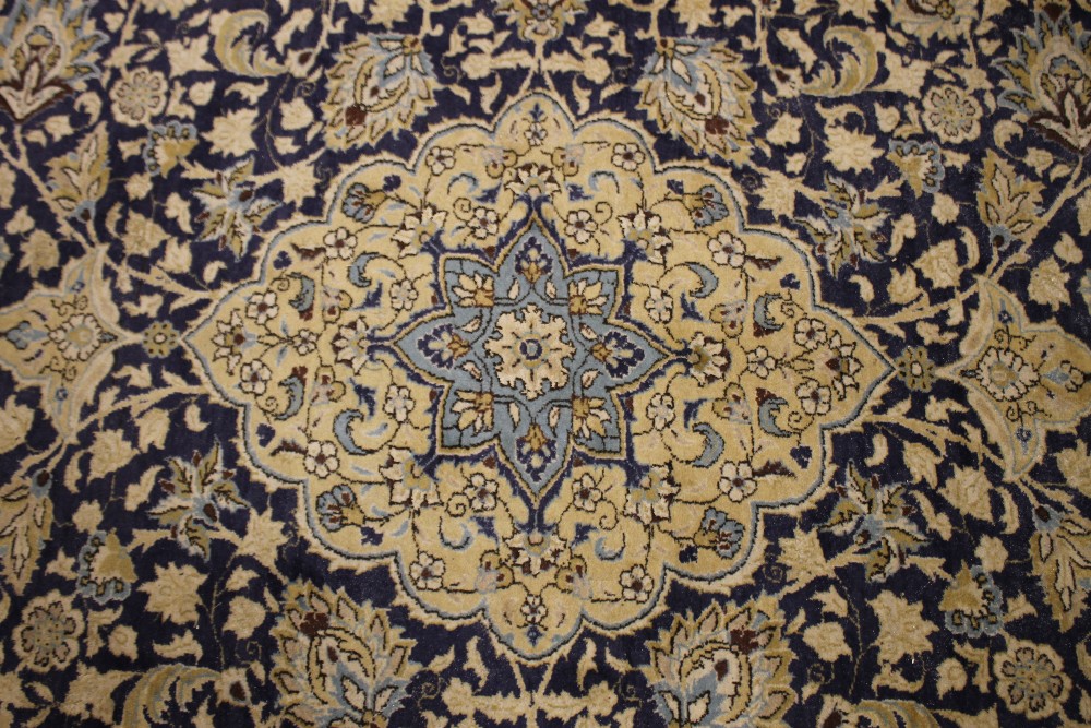 A LARGE 20TH CENTURY IRANIAN WOOLLEN RUG, with an all over pattern on a mainly blue ground, 373 x