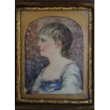 A 19TH CENTURY PORTRAIT MINIATURE OF A YOUNG GIRL IN A BLUE AND WHITE DRESS, with gilt metal