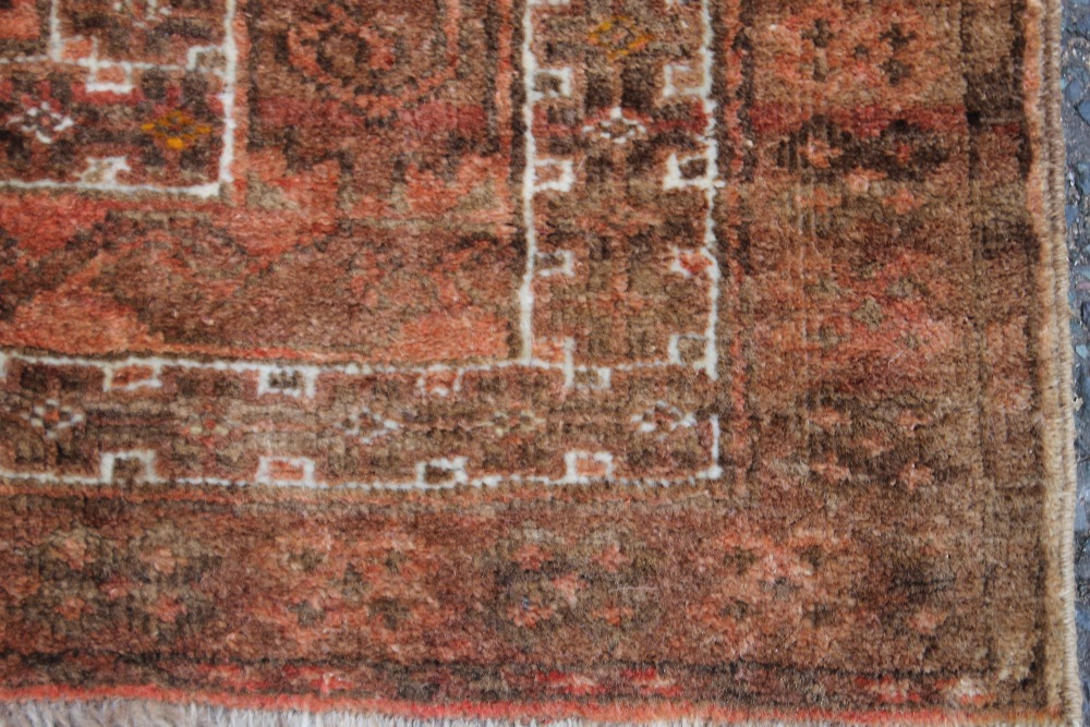 A BOKHARA STYLE WOOLLEN RUG, with an all over pattern on a mainly red ground, 137 x 208 cm - Faded - Image 3 of 6