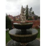 A LARGE STONE GRADUATED THREE TIER WATER FOUNTAIN, early 20th century with a cherub surmount above