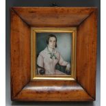 A PORTRAIT MINIATURE OF A SEATED YOUNG LADY IN A PINK DRESS WITH GREEN RIBBON, in maple frame,