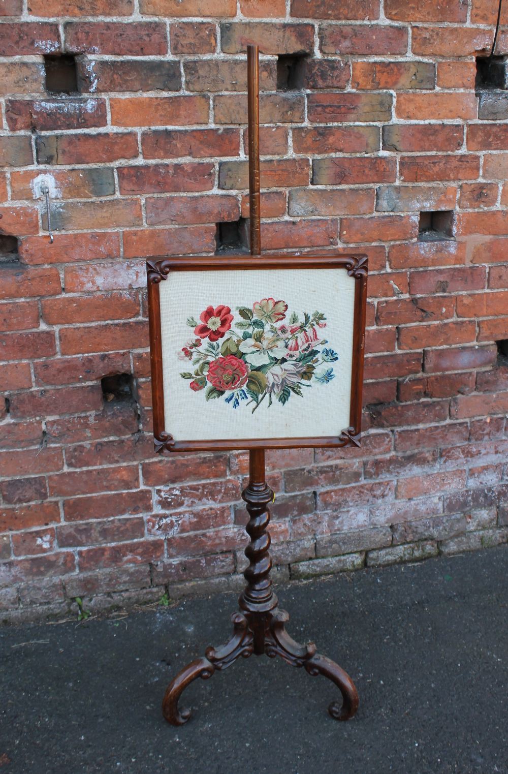 A 19TH CENTURY POLE SCREEN, the rectangular glazed screen with floral needlepoint detail, the