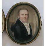 A 19TH CENTURY OVAL PORTRAIT MINIATURE OF A GENTLEMAN IN A BLUE COAT, in cased leather framed,