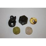 FIVE SMALL PIECES OF CARVED JADE, in various colours, one pierce hexagonal form with hole for cord