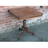 A 19TH CENTURY TILT-TOP PEDESTAL TABLE, the shaped rectangular top raised on a turned support and
