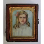 A LATE 19TH / EARLY 20TH CENTURY PORTRAIT MINIATURE OF A YOUNG GIRL IN A WHITE DRESS WITH PINK