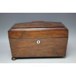 A 19TH CENTURY ROSEWOOD SARCOPHAGUS SHAPED TEA CADDY, the hinged lid opening to a part fitted