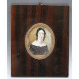 A 19TH CENTURY OVAL PORTRAIT MINIATURE OF A YOUNG LADY WITH BLACK HAIR, in fruitwood frame,