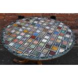 A CIRCULAR MARBLE SPECIMEN TABLE, the various specimens arranged in geometric patterns, raised on