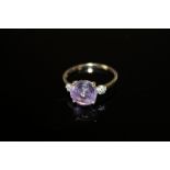 A HALLMARKED 9K GOLD AMETHYST AND DIAMOND RING, the circular amethyst measuring approx 9 mm in