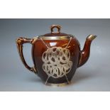 A SILVER MOUNTED TREACLE GLAZED TEAPOT, having internal ceramic infuser a/f, mounts stamped '