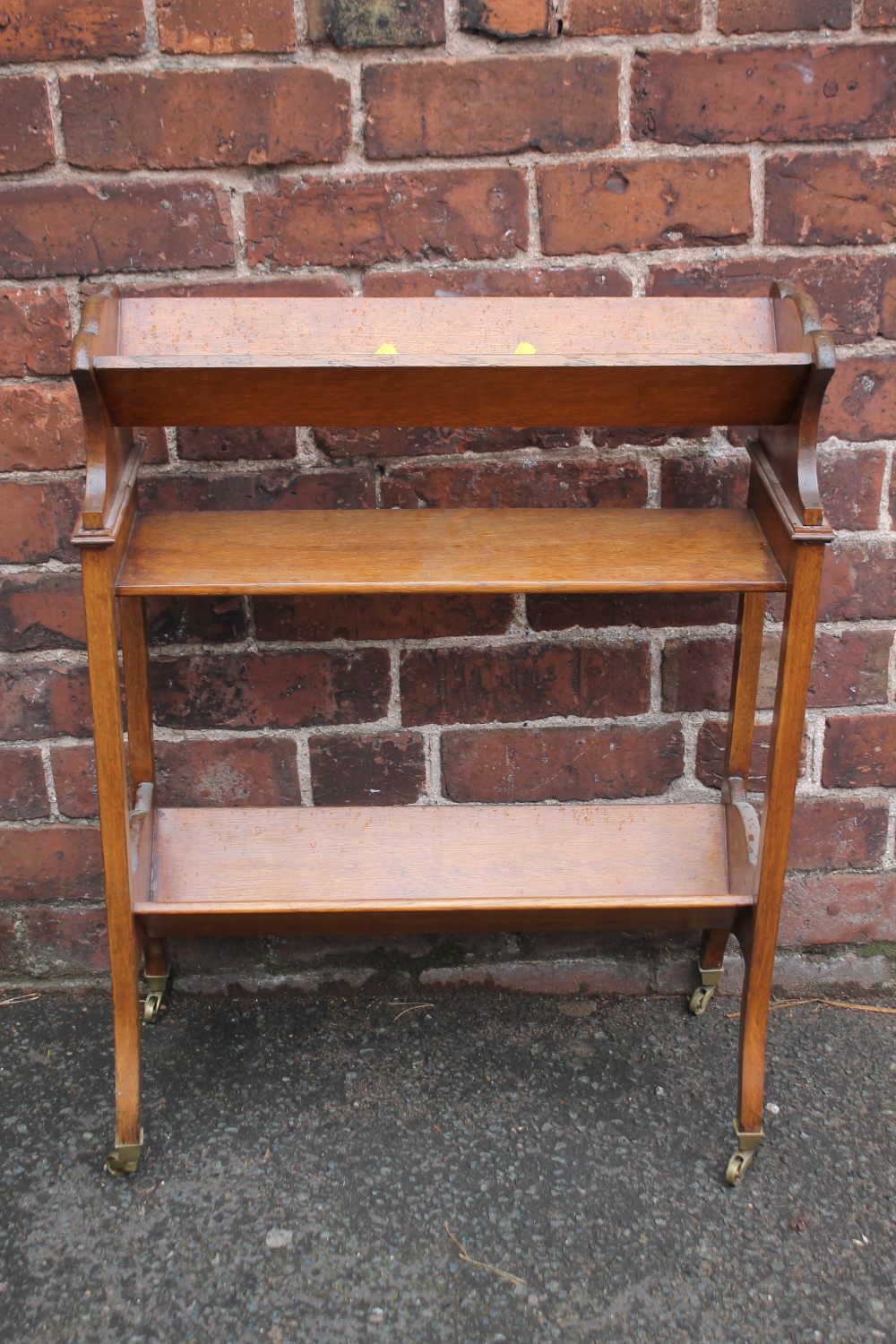 A 1920S OAK BOOK TROUGH, of three stages with shaped supports and original cappings and castors, H - Image 2 of 6