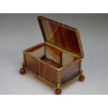 A LATE 19TH / EARLY 20TH CENTURY BANDED AGATE SMALL CASKET, with gilt metal mounts, raised on four