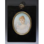 A LATE 19TH / EARLY 20TH CENTURY OVAL PORTRAIT MINIATURE OF A YOUNG LADY IN A WHITE DRESS, in