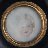 A LATE 19TH / EARLY 20TH CENTURY CIRCULAR PORTRAIT MINIATURE OF A YOUNG CHILD, in a circular black