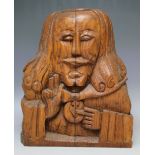 AN UNUSUAL CARVED WOODEN NAIVE HEAD, depicting a Religious male, bearing a crucifix, H 41 cm