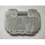 A LARGE CHINESE CELADON JADE BUCKLE / PENDANT, finely carved in shallow relief with bird and foliate