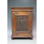 AN UNUSUAL EARLY 20TH CENTURY OAK TABLE CABINET, the single door with inset metal plaque depicting a