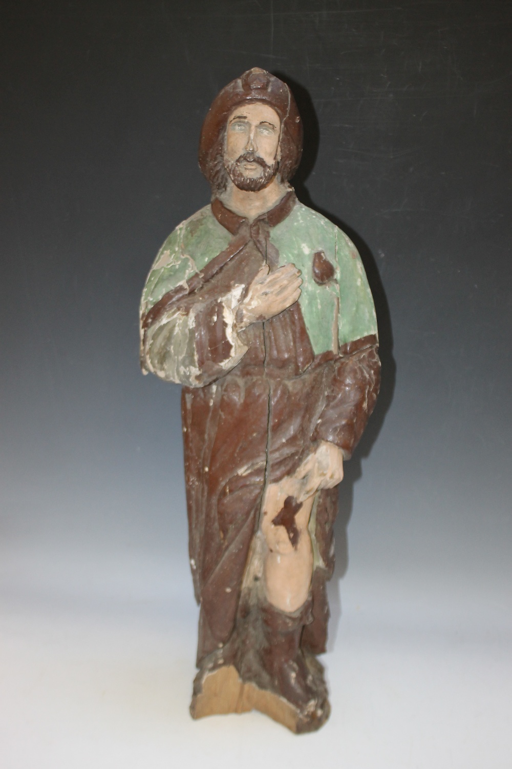 AN EARLY POLYCHROME PAINTED WOODEN FIGURE OF A FISHERMAN, H 70 cm