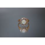 A HALLMARKED 18 CARAT GOLD OPAL AND DIAMOND RING, the circular domed opal is approx 7 mm Dia and