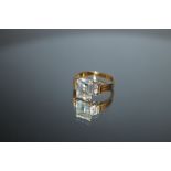 AN 18CT AQUAMARINE AND DIAMOND RING, the emerald cut aqua marine measuring approx 8mm x 6mm,