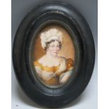 A LATE 19TH / EARLY 20TH CENTURY OVAL PORTRAIT MINIATURE OF A LADY IN A YELLOW DRESS, in oval