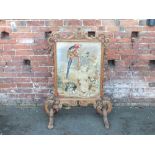 A LARGE VICTORIAN STRIPPED OAK FIRESCREEN, the frame with carved, pierced and scrolling detail,