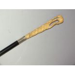 A LATE 19TH CENTURY IVORY HANDLED WALKING STICK, the handle carved as an elephant on a cobra, with
