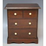 AN ANTIQUE MAHOGANY MINIATURE CHEST OF DRAWERS, with four drawers, H 24 cm, W 21 cm