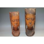 A NEAR PAIR OF TRIBAL ART CARVED HEADS, depicting typical females, largest H 38.5 cm , smallest H 34