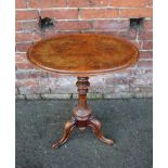 A VICTORIAN WALNUT OCCASIONAL TABLE, the oval top raised on a fluted column and tripod feet, H 72