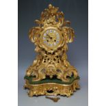 A FRENCH GILT METAL MANTEL CLOCK, the movement stamped Henry Marc, Paris, with pierced swirling