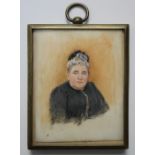 A LATE 19TH / EARLY 20TH CENTURY PORTRAIT MINIATURE OF A LADY IN A BLACK DRESS, in a gilt metal