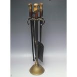 AN UNUSUAL 'BAYONET' FIRESIDE COMPANION SET, central column with brass mounts and circular base, the