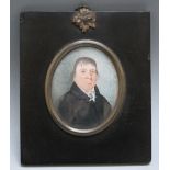 A LATE 19TH CENTURY OVAL PORTRAIT MINIATURE OF A GENTLEMAN IN BLACK COAT WITH WHITE CRAVAT, in black