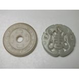 A CHINESE CELADON JADE CARVED AND PIERCED CIRCULAR PENDANT, with central character mark, Dia. 5.7