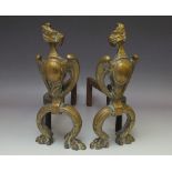 A PAIR OF LATE 19TH / EARLY 20TH CENTURY BRASS FIRE DOGS, with Griffin mask surmount and paw feet, H