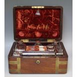A 19TH CENTURY ROSEWOOD FITTED DRESSING CASE WITH AN ASSORTMENT OF SILVER HALLMARKED BOTTLES AND