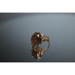 A HALLMARKED 9 CARAT GOLD LARGE SMOKY QUARTZ RING, the oval stone measures approx 16 mm x 12 mm,