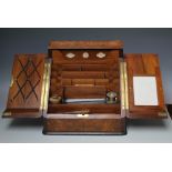 A VICTORIAN WALNUT TABLE TOP STATIONARY CABINET, the twin hinged doors opening to reveal fully