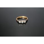 AN 18 CARAT GOLD THREE STONE DIAMOND RING, ring size LCondition Report:`