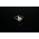 AN 18 CT GOLD DIAMOND CLUSTER, with diamond set shoulders, the central diamond being approx 0.25 ct,