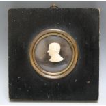 A 19TH CENTURY CIRCULAR MINIATURE CARVED IVORY BUST OF A GENTLEMAN, in a black framed, unsigned,