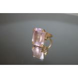 A HALLMARKED 9 CARAT GOLD DRESS RING, set with large emerald cut lilac stone, possibly amethyst,