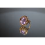 A HALLMARKED 9 CARAT GOLD AMETHYST RING, in ornate high set gallery, approx 14 mm x 10 mm, approx