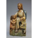 AN ANTIQUE POLYCHROME FIGURATIVE CARVING, depicting a seated bearded gentleman with children and