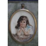 A TWENTIETH CENTURY OVAL PORTRAIT MINIATURE OF A YOUNG GIRL, in a gilt metal framed, set in a blue