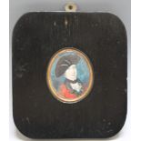 A 19TH CENTURY OVAL PORTRAIT MINIATURE OF AN OFFICER IN RED UNIFORM AND BLACK HAT, in a black
