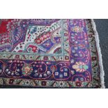 A LARGE WOOLLEN AFGHAN RUG, with an all over pattern on a mainly red and blue ground, 285 x 198 cm