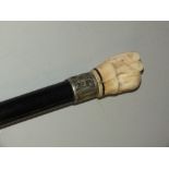 A LATE 19TH CENTURY IVORY HANDLED WALKING CANE, the handle carved as an elephant, with a white metal